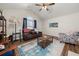 Spacious living room with hardwood floors, a ceiling fan, and comfy seating at 204 Somerton Pl, Cumming, GA 30040