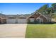 Brick front townhouse with a two car garage at 204 Somerton Pl, Cumming, GA 30040