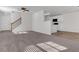 Open living room with kitchen views, stairs, and neutral carpeting at 124 Silver Fox Trl, Dallas, GA 30157