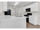 Modern kitchen with white cabinets, black appliances, and tile floor at 124 Silver Fox Trl, Dallas, GA 30157