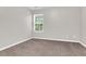 Simple bedroom with a window and neutral walls at 124 Silver Fox Trl, Dallas, GA 30157