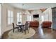 Breakfast area with round table and chairs, hardwood floors, and a view of the living room at 187 Fontaine Sw Rd, Mableton, GA 30126