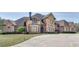 Large brick home with stone accents, a circular driveway, and manicured lawn at 187 Fontaine Sw Rd, Mableton, GA 30126