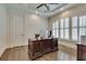 Bright home office features hardwood floors, built-in shelving, and plantation shutters at 187 Fontaine Sw Rd, Mableton, GA 30126