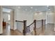 Elegant upper hallway with hardwood floors and wrought iron railing at 187 Fontaine Sw Rd, Mableton, GA 30126