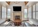 Living room with vaulted ceiling, stone fireplace, hardwood floors, and large windows at 187 Fontaine Sw Rd, Mableton, GA 30126