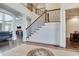 Impressive two-story staircase with wrought-iron railing and hardwood steps at 187 Fontaine Sw Rd, Mableton, GA 30126