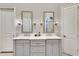 Bathroom with double vanity, marble countertops, and large mirrors at 187 Fontaine Sw Rd, Mableton, GA 30126
