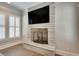 Basement fireplace with stone surround and large TV above at 187 Fontaine Sw Rd, Mableton, GA 30126
