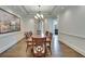Bright dining room with hardwood floors, tray ceiling, and large artwork at 187 Fontaine Sw Rd, Mableton, GA 30126