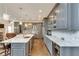 Modern kitchen featuring gray cabinets and marble island at 187 Fontaine Sw Rd, Mableton, GA 30126