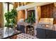 Outdoor kitchen with brick grill, wood storage, and stainless steel appliances at 2288 Peachtree Nw Rd # 6, Atlanta, GA 30305