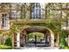 Grand gated entrance with lush greenery and wrought iron details at 2288 Peachtree Nw Rd # 6, Atlanta, GA 30305