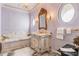 Spa-like bathroom with marble bathtub and vintage vanity at 2288 Peachtree Nw Rd # 6, Atlanta, GA 30305