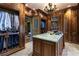 Large walk-in closet with custom wood shelving and island at 2288 Peachtree Nw Rd # 6, Atlanta, GA 30305