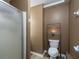 Basement bathroom with shower, toilet and shelving unit at 304 Ridge Hill Cir, Canton, GA 30115