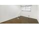Empty bedroom with hardwood floors and a window with blinds at 2210 Rhinehill Se Rd, Atlanta, GA 30315