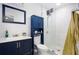Clean bathroom features a navy vanity, white subway tile, and a glass shower at 2210 Rhinehill Se Rd, Atlanta, GA 30315