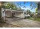 Ranch house features carport, landscaping, and a green front door at 2210 Rhinehill Se Rd, Atlanta, GA 30315
