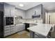 Updated kitchen with gray cabinets, marble countertops, and modern appliances at 2210 Rhinehill Se Rd, Atlanta, GA 30315