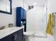 Bathroom with navy vanity, white subway tile, and glass shower at 2210 Rhinehill Se Rd, Atlanta, GA 30315