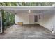 Covered carport provides shelter for vehicles and storage at 2210 Rhinehill Se Rd, Atlanta, GA 30315