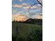 Scenic sunset view over grassy field and trees at 4800 Pisgah Rd, Cumming, GA 30028