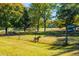 Goat enclosure with wire fencing, grassy area, and mature trees in background at 4800 Pisgah Rd, Cumming, GA 30028