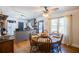 Open kitchen and dining area with gray cabinets, island, hardwood floors, and a view to backyard at 4800 Pisgah Rd, Cumming, GA 30028