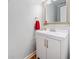 Clean and updated half bathroom with white vanity and hardwood floors at 401 Briardale Ct, Woodstock, GA 30189