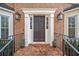 Dark brown front door with brick columns and sidelights at 401 Briardale Ct, Woodstock, GA 30189