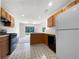 Kitchen with wood cabinets, black appliances, and a view to the backyard at 104 Silver Fox Trl, Dallas, GA 30157