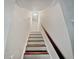 Wooden staircase with simple design and white walls at 2988 Woodrow Mnr, Lithonia, GA 30038