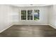 Bright living room with vinyl flooring and large windows at 2988 Woodrow Mnr, Lithonia, GA 30038
