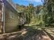 Tan house with a deck and a large backyard at 2988 Woodrow Mnr, Lithonia, GA 30038