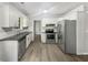 Modern kitchen featuring white cabinets, granite countertops, and stainless steel appliances at 2988 Woodrow Mnr, Lithonia, GA 30038