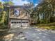 Two-story house with a double garage and a tree-lined driveway at 2988 Woodrow Mnr, Lithonia, GA 30038