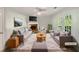 Virtually staged living room with fireplace and access to deck at 2988 Woodrow Mnr, Lithonia, GA 30038