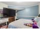Primary bedroom with large TV and walk-in closet at 422 White Oak Nw Dr, Lilburn, GA 30047