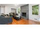 Cozy living room featuring a brick fireplace and hardwood floors at 422 White Oak Nw Dr, Lilburn, GA 30047