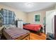 Bedroom with two twin beds, dresser, and wood floors at 422 White Oak Nw Dr, Lilburn, GA 30047