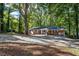 Brick ranch house with carport and wooded backyard at 422 White Oak Nw Dr, Lilburn, GA 30047