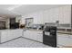 Galley kitchen with white cabinets, granite countertops, and tile floors at 422 White Oak Nw Dr, Lilburn, GA 30047