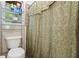 Small bathroom with a toilet and shower/tub combo at 422 White Oak Nw Dr, Lilburn, GA 30047