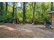 Wooded backyard with storage shed and play area at 422 White Oak Nw Dr, Lilburn, GA 30047