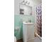 Bathroom with mint green tile, shower, and vanity at 422 White Oak Nw Dr, Lilburn, GA 30047