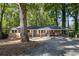 Brick ranch house with a carport and mature trees at 422 White Oak Nw Dr, Lilburn, GA 30047