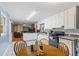 Eat-in kitchen with white cabinets, granite countertops, and tile floors at 422 White Oak Nw Dr, Lilburn, GA 30047