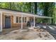Brick ranch house with covered carport and a gray front door at 422 White Oak Nw Dr, Lilburn, GA 30047