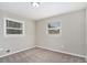 Bright bedroom with neutral walls and carpet, featuring two windows with blinds at 2434 Miriam Ln, Decatur, GA 30032
